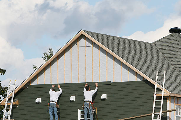 Professional Siding technician working in Dedham, MA